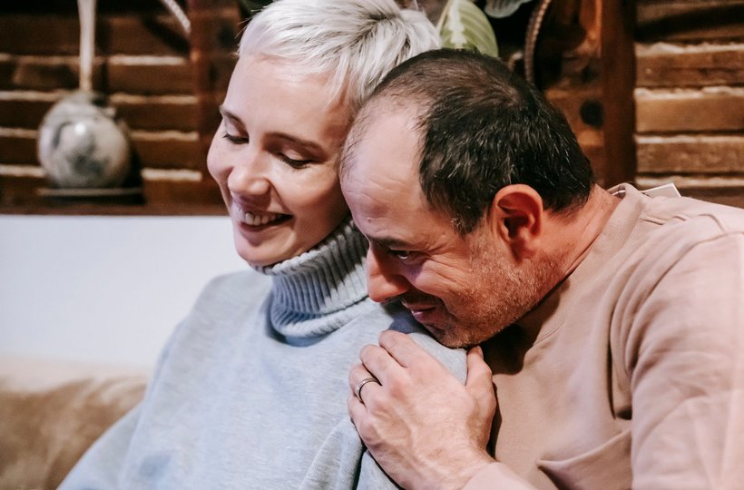 A couple sharing a laugh at home