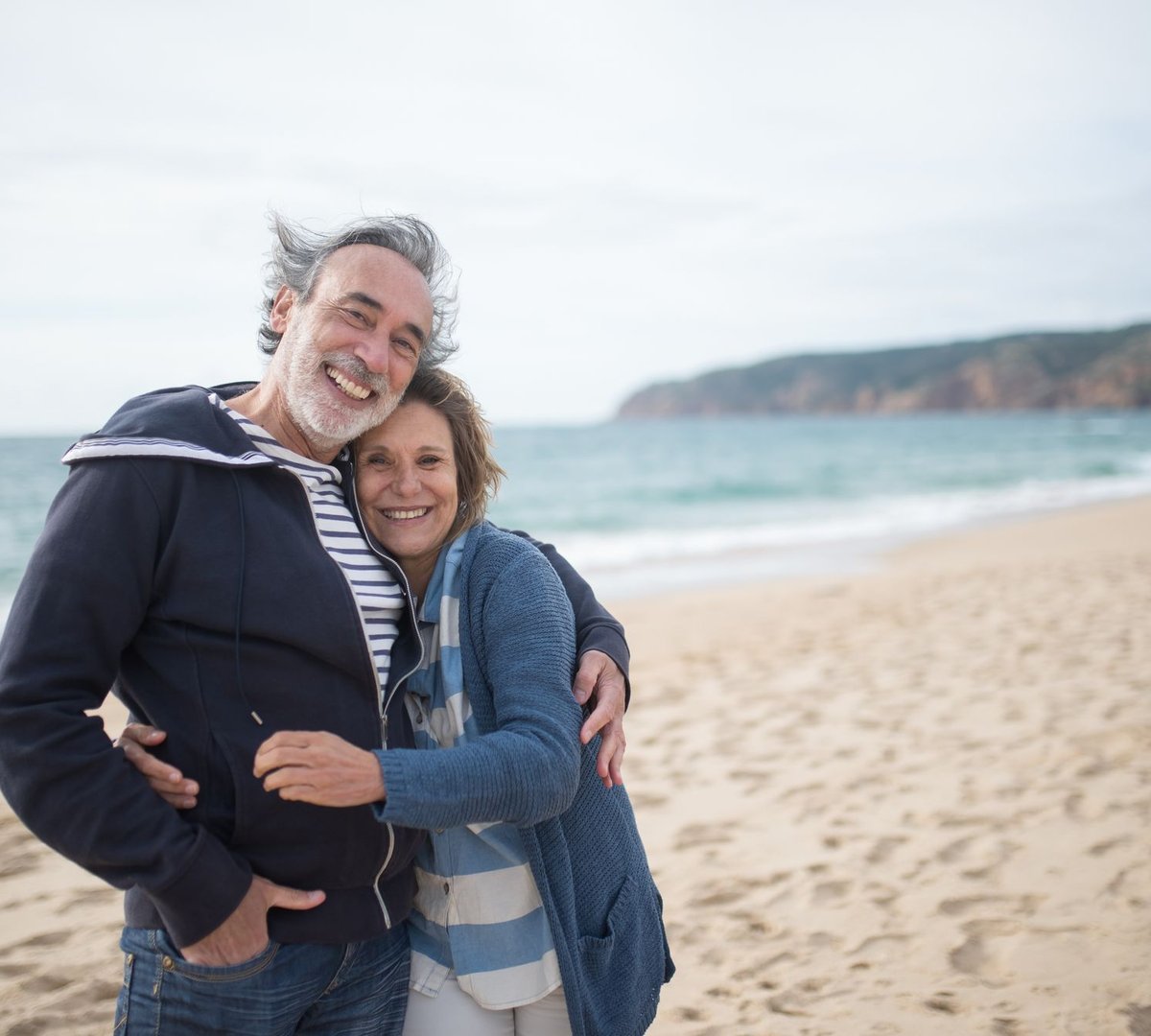 A couple smiling together on the beach