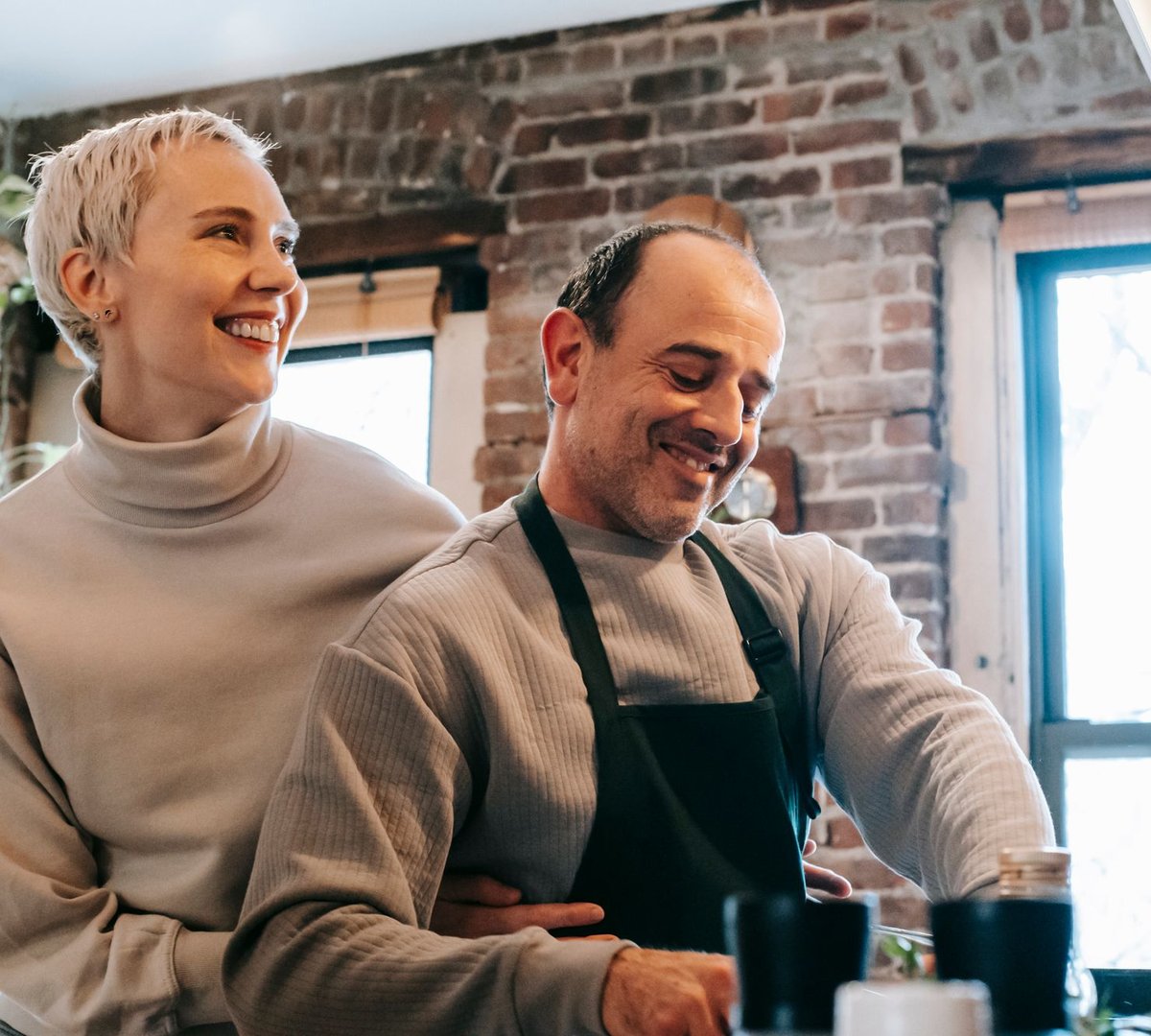 A couple cooking together in the kitchen