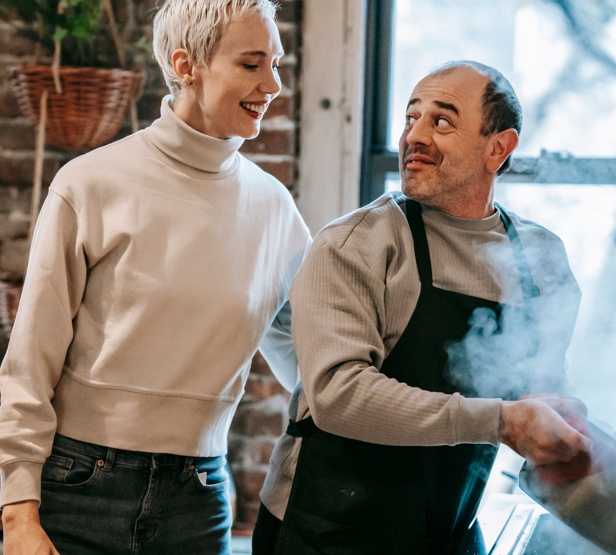 A couple laughing in the kitchen