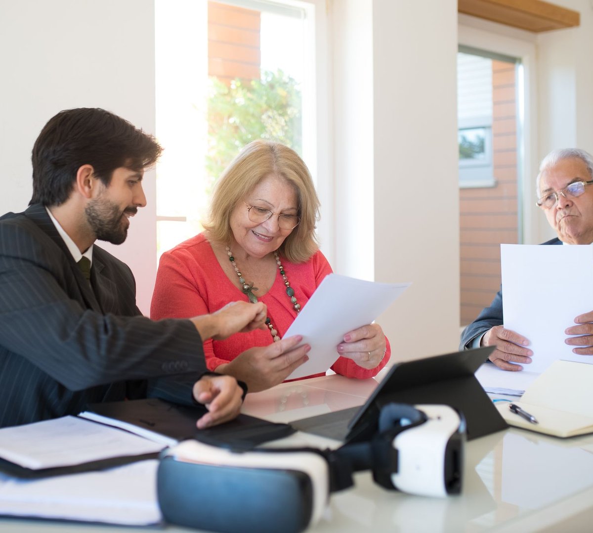 A couple reviewing papers with a professional