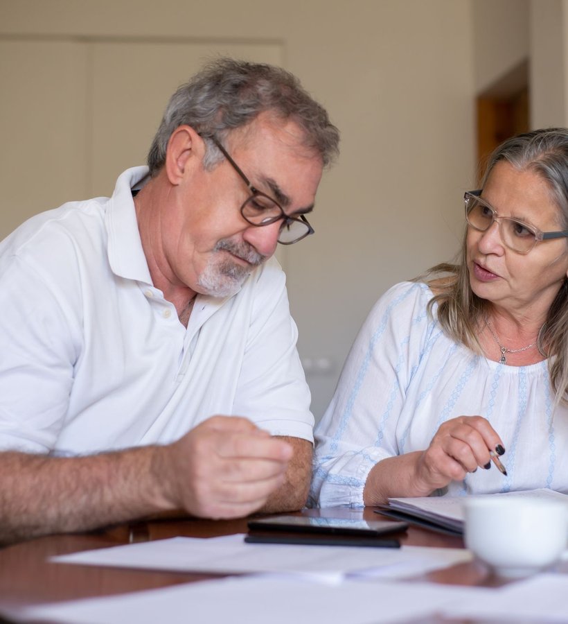 A couple going over their budget together at the table