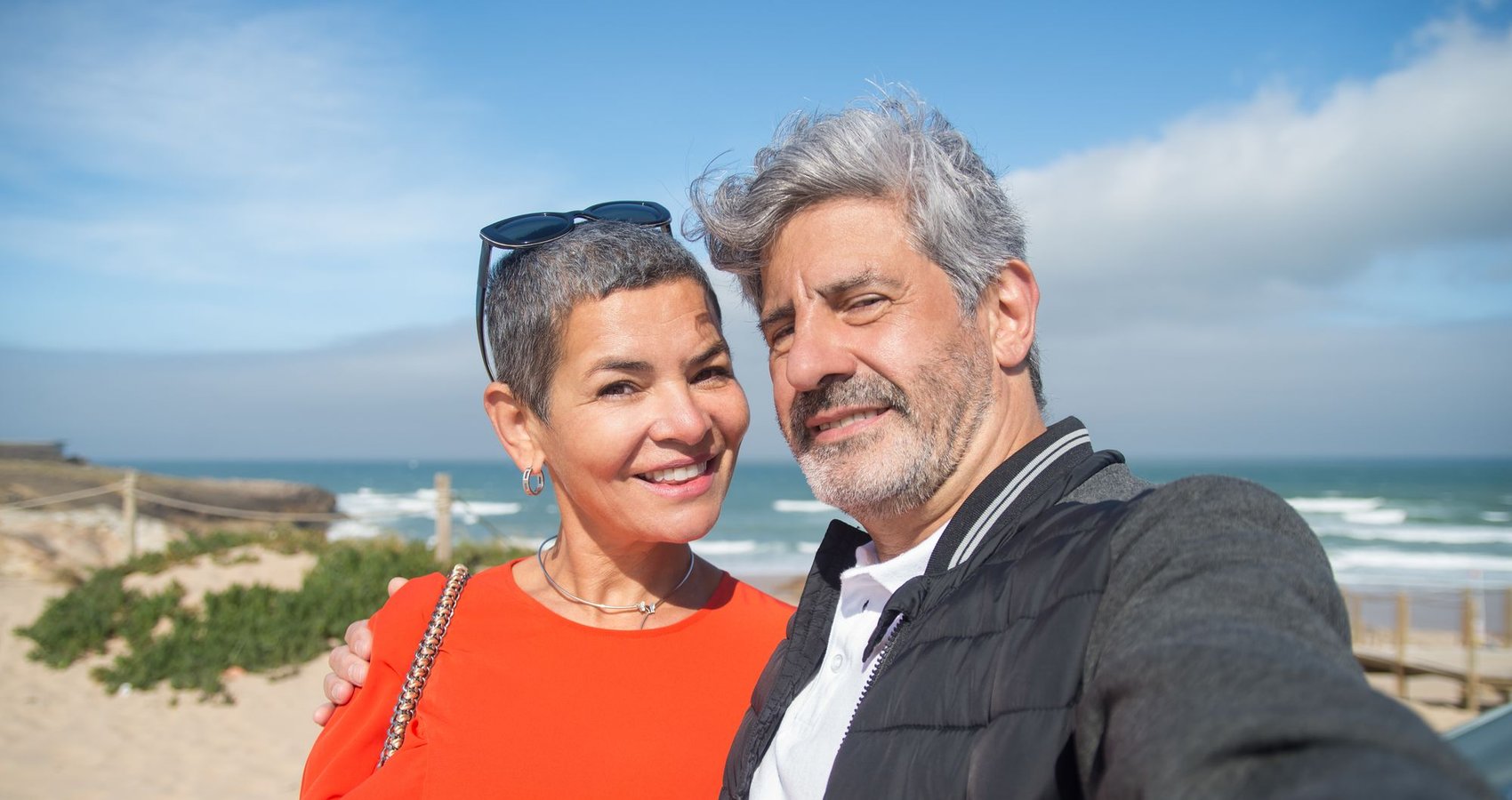 A couple taking a selfie on a seaside trip