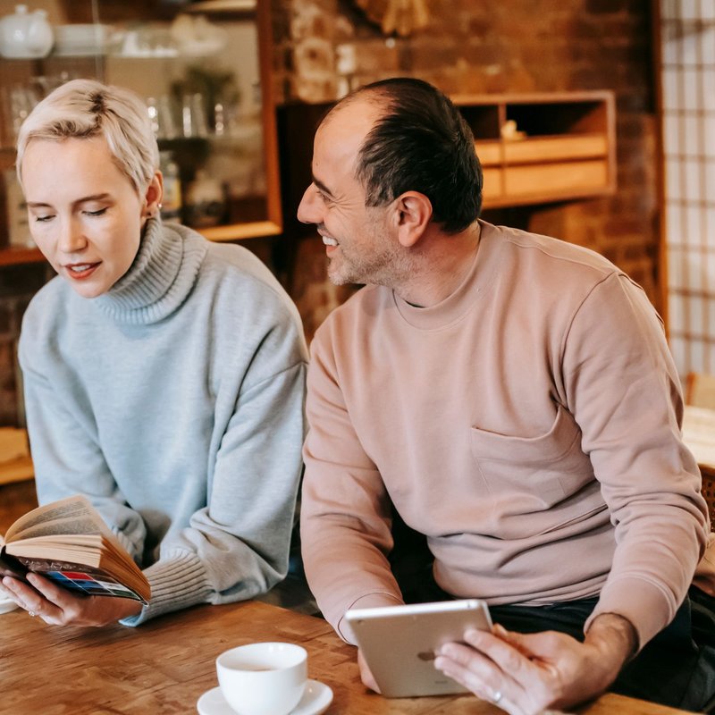 A couple reading together at a café